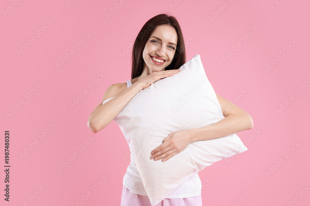 Obraz premium Beautiful woman with pillow on pink background