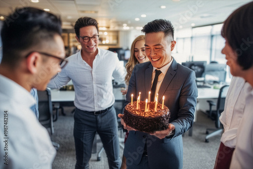 Business background of birthday celebration of young male business executive in office 