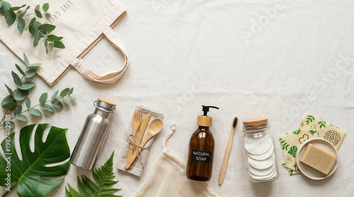 Zero waste lifestyle flat lay with reusable eco products, natural skincare items and sustainable daily essentials on light background with copy space 