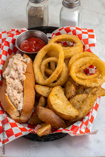 tuna salad boat  with potato wedges and onion rings