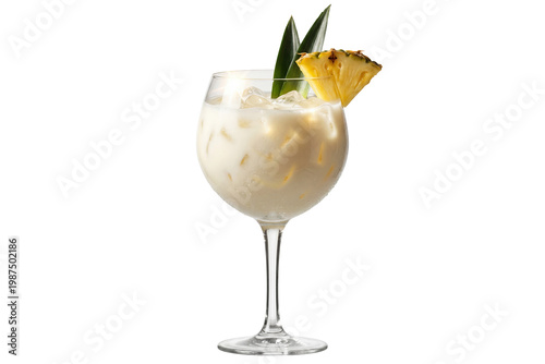 creamy pineapple cocktail with pineapple wedge and leaves in a balloon glass on transparent background