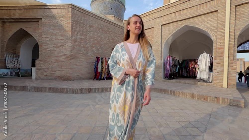 Woman in traditional Uzbek dress at Hazrati Imam Complex Tashkent