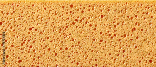 Yellow orange sponge showing porous foam texture closeup