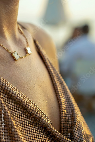 Woman wearing luxury gold necklace during golden hour