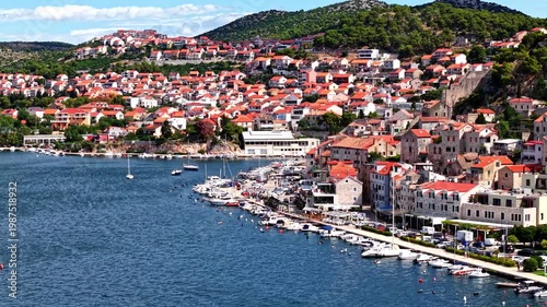 Aerial view of Sibenik old town and harbor, Croatia, Mediterranean coastal city with red roofs and boats in the marina
