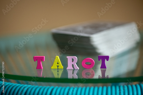 Wallpaper Mural Tarot. Divination by tarot cards and prediction of the future concept. Wooden letters the "tarot" word with a blurred tarot cards on the background. Selective focus. Torontodigital.ca