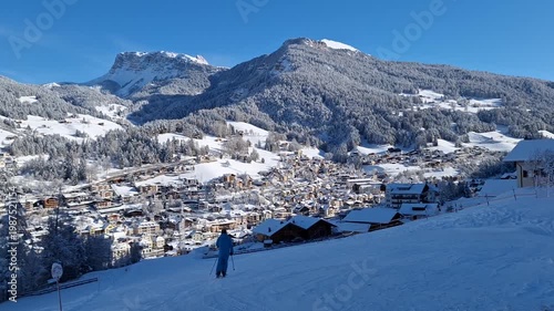 Skiers escape from the mountain slope in the town of Ortisei.