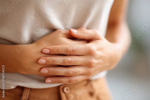 Person holding stomach in discomfort