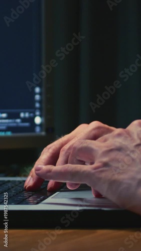 Man stock trader in home office, typing on a laptop keyboard. Male forex broker analyzes terminal, trades stocks on crypto market. Smartphone monitor, candlestick or trading charts, price action