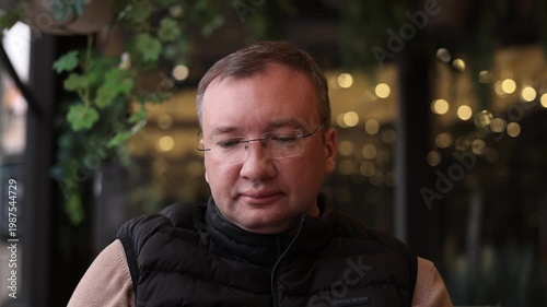 Portrait of a man relaxing in a cafe, close-up.