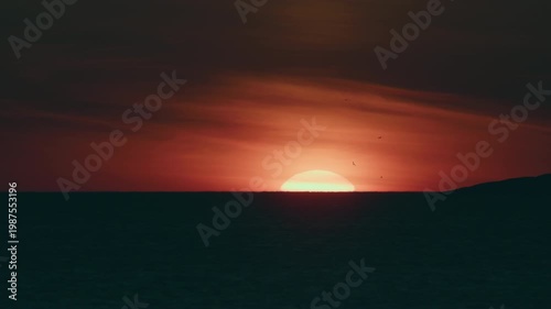 Sunset Over Silhouetted Landscape With Seagulls In Slow Motion.