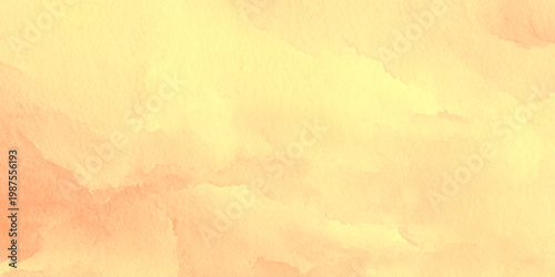 Warm yellow orange watercolor background texture with soft peach tones and abstract brushstrokes for design and artistic projects