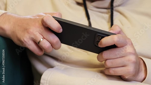 A man holds a smartphone in his hands, close-up, slow motion video.