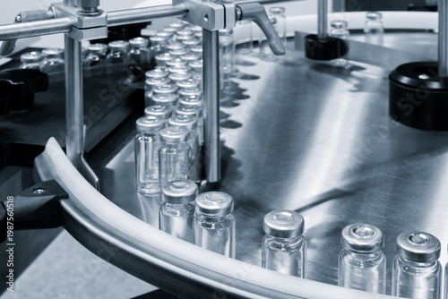 Pharmaceutical industry. Production line machine conveyor with glass bottles ampoules at factory. Pharmaceutical industry concept background.