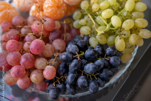 Wallpaper Mural Black, white and red grapes on a glass plate. Three types of grapes served for a party. Selective focus. Torontodigital.ca