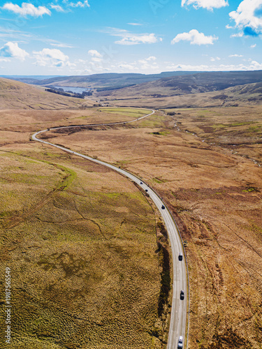 Carter Bar Scotland: 14th March 2026: Drone view of the A68 road winding through Cheviot Hills, on the Anglo-Scottish border on a sunny Springtime day