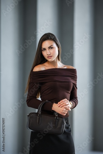 Wallpaper Mural Caucasian Woman Closeup Editorial Beauty Offshoulder Brown Top, Sleek Long Hair, Holding Structured Black Torontodigital.ca