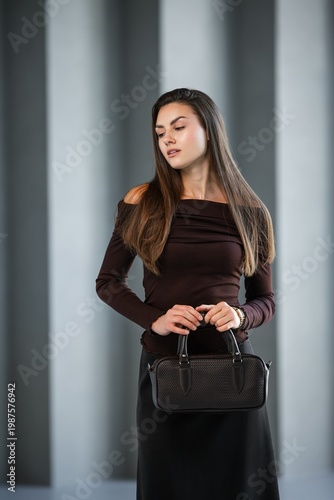 Wallpaper Mural Caucasian Woman Fulllength Standing Poised With Handbag, Offshoulder Brown Top And Black Midi Skirt, Black Torontodigital.ca