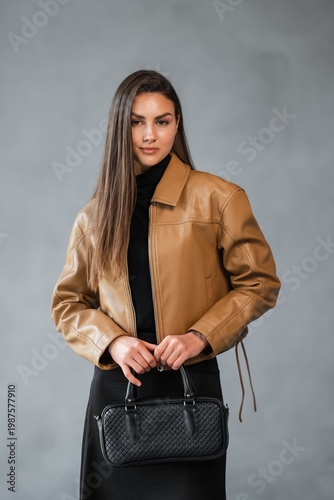 Wallpaper Mural Caucasian Woman Entrepreneur Holding Woven Black Handbag, Frontal Portrait With Direct Gaze, Polished Leather Torontodigital.ca