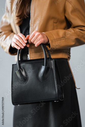 Wallpaper Mural Caucasian Woman Stylist Handling Smooth Black Leather Bag, Closeup On Hands And Handle, Tactile Texture Torontodigital.ca