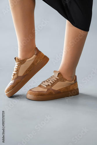 Wallpaper Mural Close View Of Legs With Stylish Sneakers. Focus On Shoes Highlighting Texture And Relaxed Atmosphere Torontodigital.ca