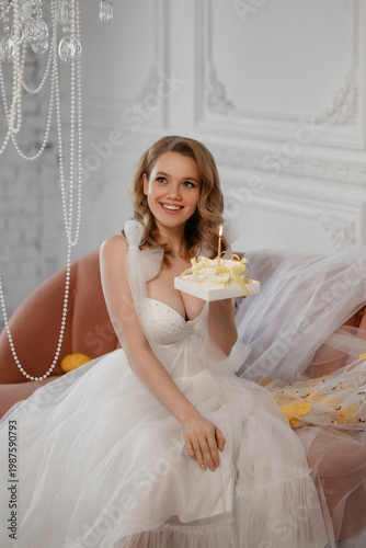 Bride Holding Small Cake With Lit Candle, Warm Glow On Smiling Face, Pearl Details On Corset, Delicate Ribbon And Intimate Editorial Framing, Soft Makeup And Elegant Styling