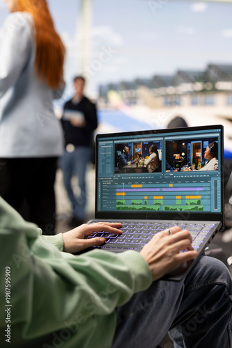 фотографія Young woman videographer working on video production in airport waiting area, editing footage and adding transitions for a cinematic film project