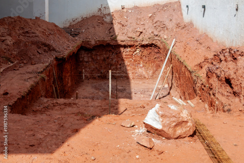 Foto Excavated hole for a swimming pool at a residential construction site