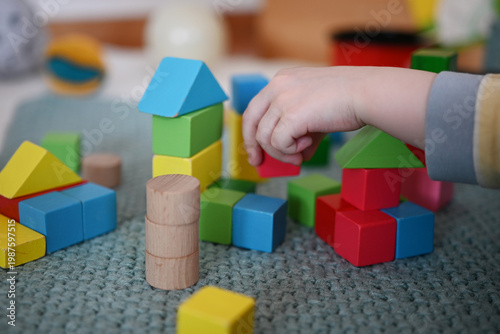 A toddler is playing with building blocks 