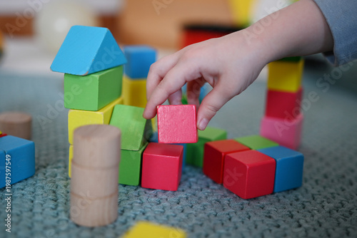 A toddler is playing with building blocks 