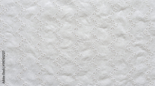 Φωτογραφία White textile with vertical zigzag eyelet embroidery pattern