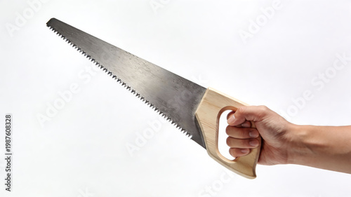 Man hand holding a classic wood hand saw with wooden handle isolated on white background. Carpentry and DIY tool.