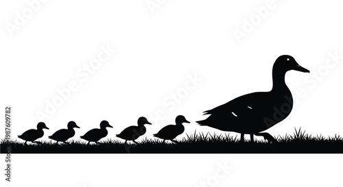 A mother duck leads her ducklings across grassy terrain silhouette