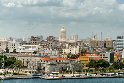 Cuba, Havana.  View of downtown Havana from the Castillo del Morro.  The Capital Building is prominent in the background.