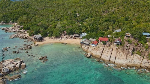 Village Houses Overlooking Crystal Waters. Remote Bay With Weathered Cottages And Lush Forest Backdrop
