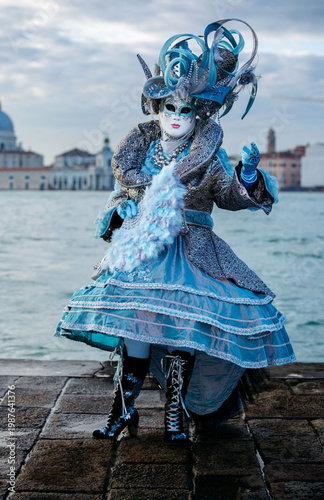 Fotografija Venice, Italy - February 08, 2026: Elegant masked figure in blue costume with el