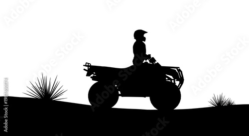 Silhouette of a person riding an ATV quad bike on outdoor terrain