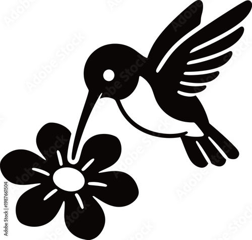 Silhouette of a hummingbird feeding from a flower