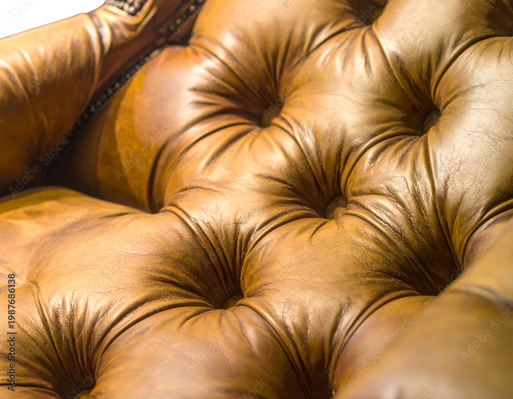 Fototapeta premium Close-up of richly textured, tufted, brown leather upholstery