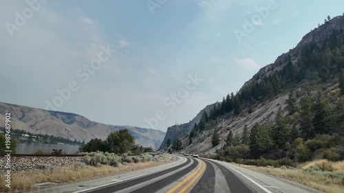 Landscape of mountain and road. Travel destination. Landscape route. Scenic nature autoroute. Rainy weather road among mountain. Road though mountain landscape