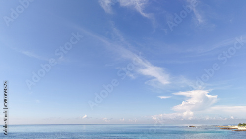 Φωτογραφία Beautiful Blue Sky with Wispy White Clouds over Calm Tropical Ocean Horizon