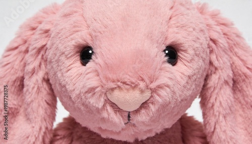 Close up of a soft pink fluffy bunny rabbit stuffed animal toy with big eyes and long ears