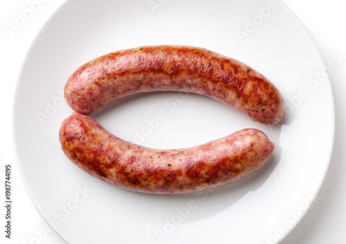 Two browned, juicy sausages arranged on a plain white plate, top-down view