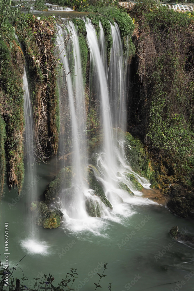Fototapeta premium Waterfall flows in a forest during daytime at duden waterfall in antalya