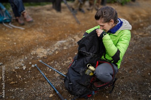 Tableau sur toile Una joven excursionista prepara su equipo para una caminata.