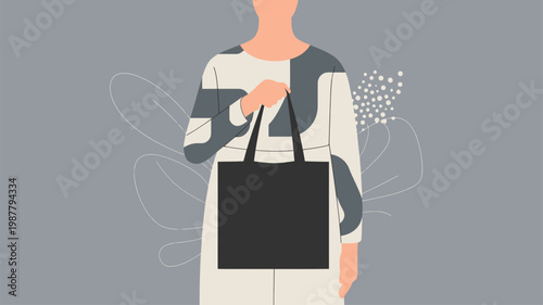 Woman holding blank black tote bag for custom branding display