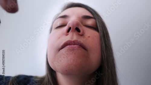 Latina woman using nasal strip for better sleep and breathing - Biohacking and wellness concept