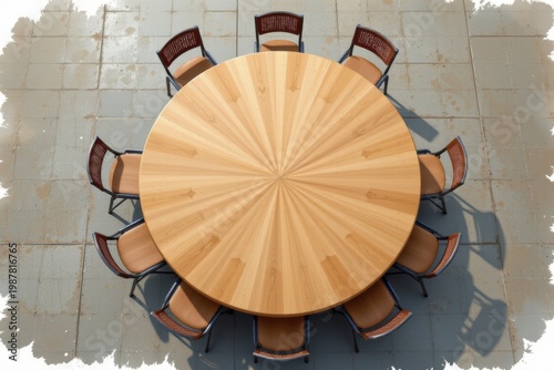 Top-down view of a round wooden table with eight chairs on tiled flooring.
