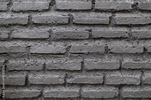 Rough grey brick wall texture with uneven mortar joints