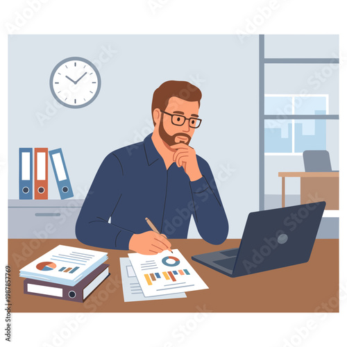 Man sitting at office desk working on laptop and papers with clock